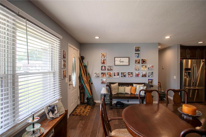 Dining room featuring dark wood finished floors, baseboards, and recessed lighting
