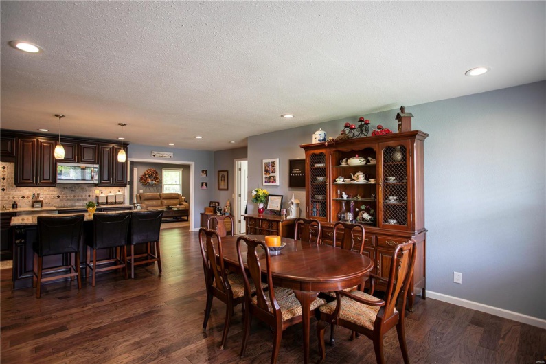Dining area with recessed lighting, dark wood finished floors, a textured ceiling, and baseboards