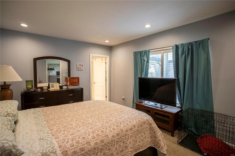 Bedroom with arched walkways and recessed lighting