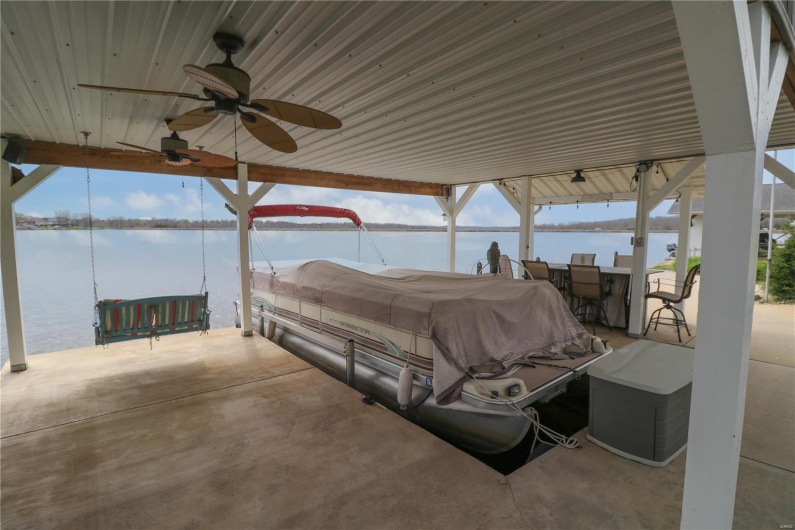 View of patio / terrace featuring a ceiling fan and a water view