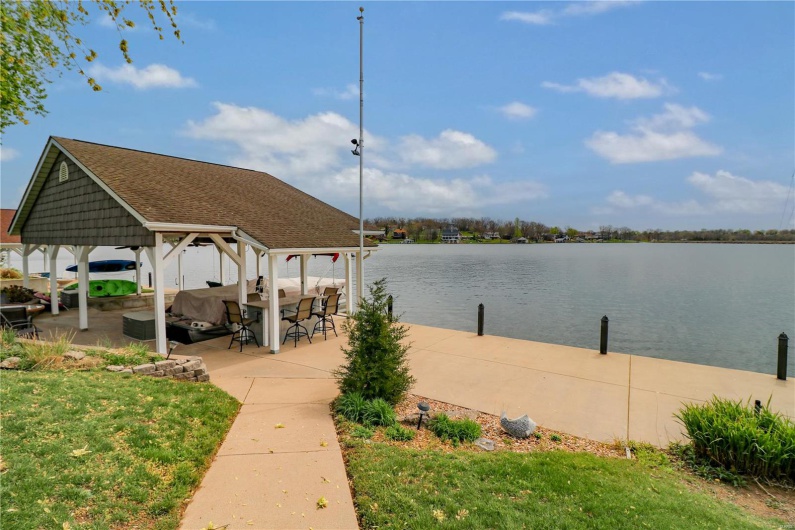 Dock area featuring a patio, a lawn, a gazebo, and a water view