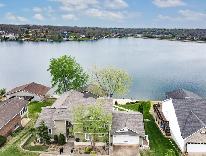 Birds eye view of property with a residential view and a water view