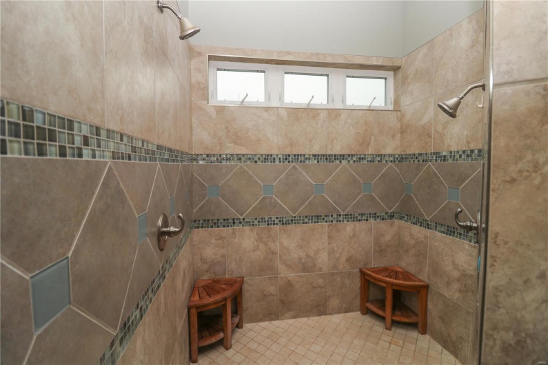 Full bath featuring a healthy amount of sunlight and tiled shower