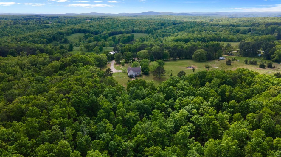 Aerial view of a heavily wooded area and mountains
