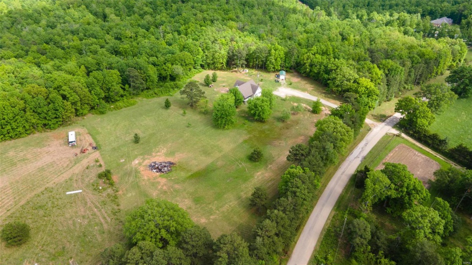 Aerial view of sparsely populated area with a forest
