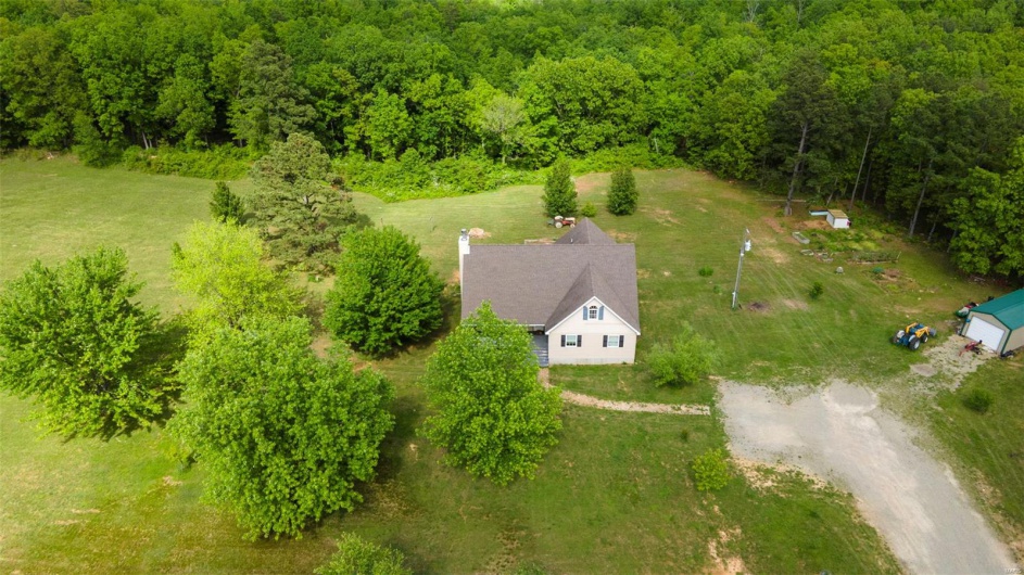 View from above of property with a heavily wooded area
