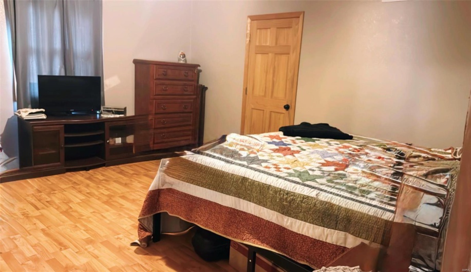 Bedroom featuring wood finished floors