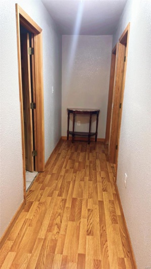 Hall featuring light wood-type flooring
