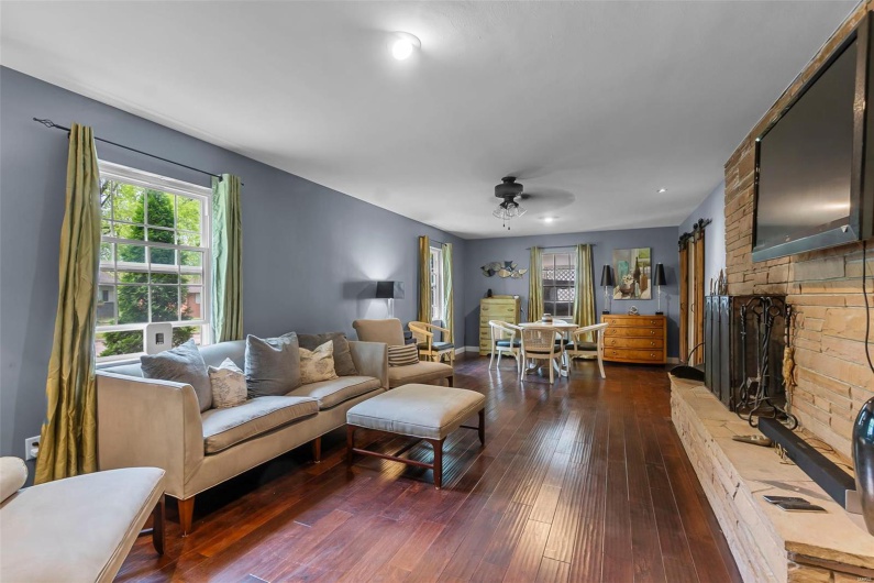 Living area with hardwood / wood-style flooring and a ceiling fan