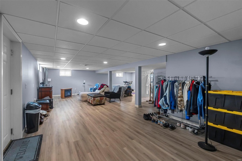 Workout area with recessed lighting, wood finished floors, baseboards, and a paneled ceiling