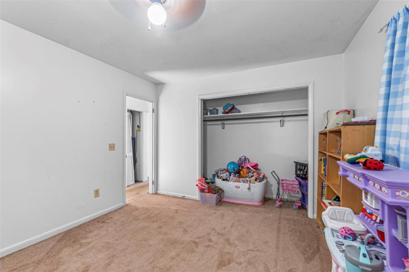 Recreation room featuring baseboards, a ceiling fan, and carpet flooring