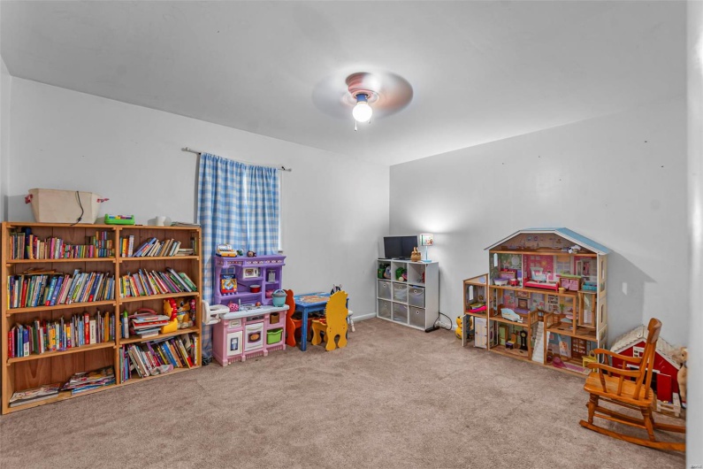 Recreation room with ceiling fan and carpet floors