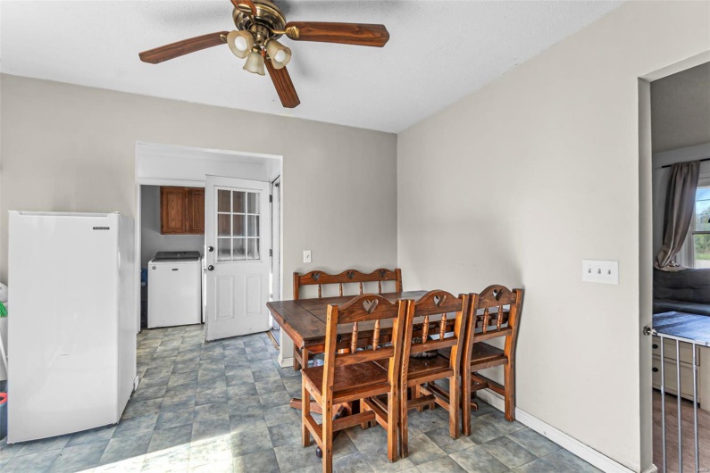 Dining space with ceiling fan and baseboards