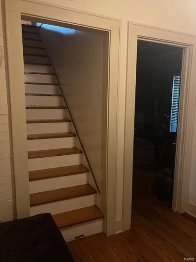 Staircase with hardwood / wood-style flooring