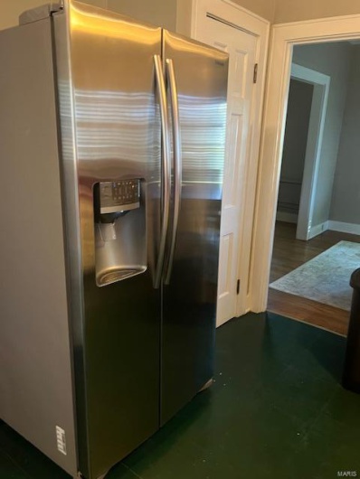 Kitchen featuring stainless steel fridge with ice dispenser and dark hardwood / wood-style flooring