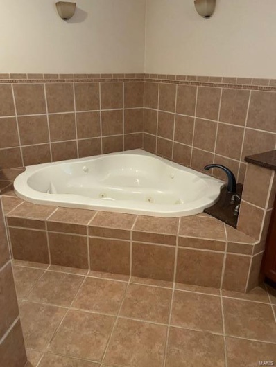 Bathroom featuring tile patterned floors and tiled bath