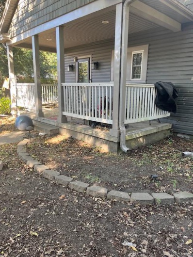 View of side of property with a porch