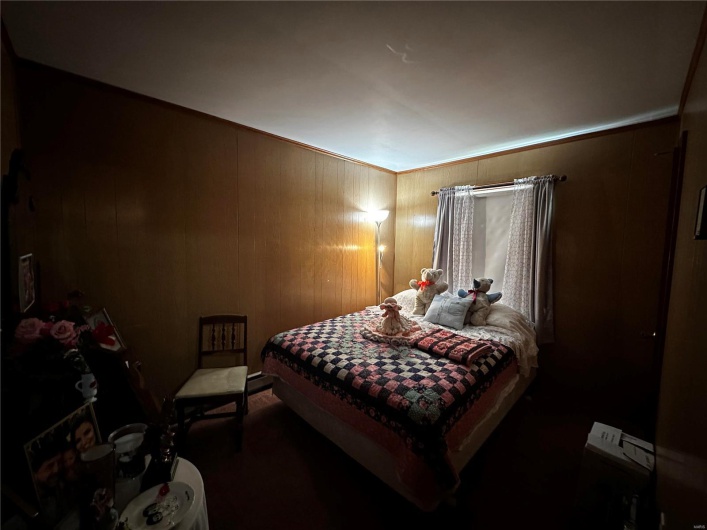 Bedroom with wooden walls