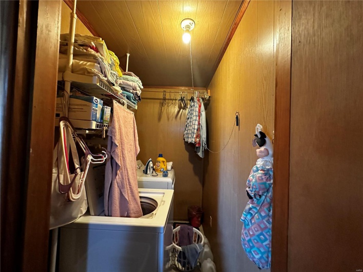 Washroom featuring wood walls