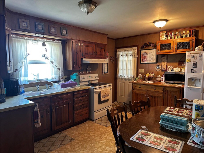 Kitchen with white appliances and sink