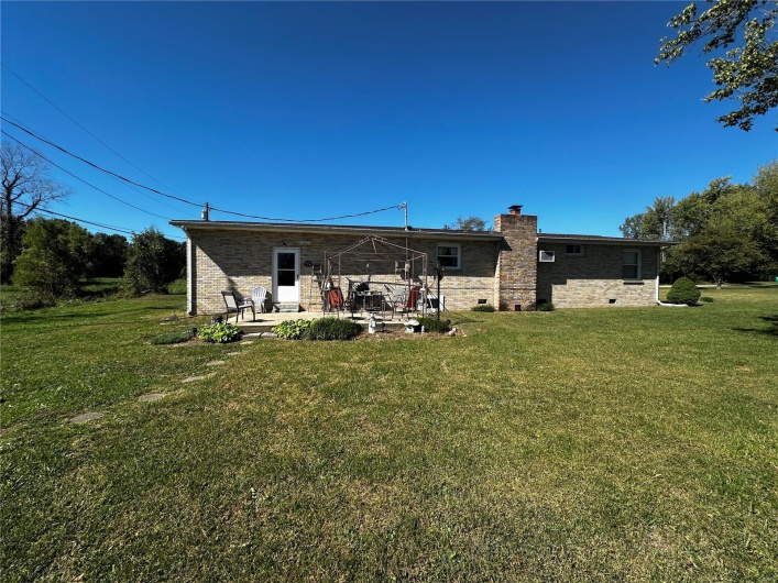 Rear view of house featuring a patio area and a yard