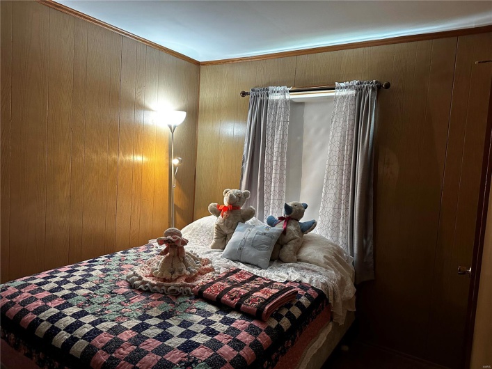 Bedroom featuring wooden walls