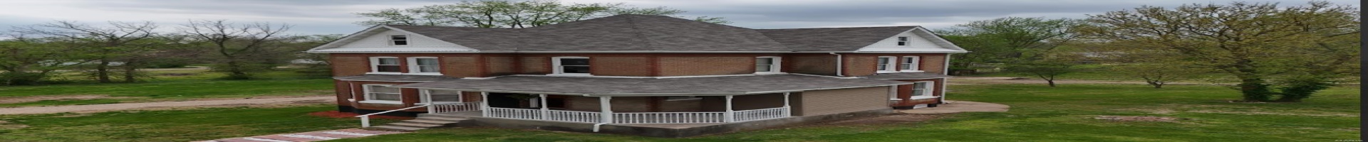 Residential For Sale Back of property with brick siding, a lawn, and roof with shingles