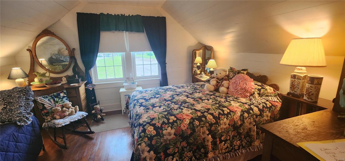 Upstairs Bedroom featuring vaulted ceiling and wood finished floors
