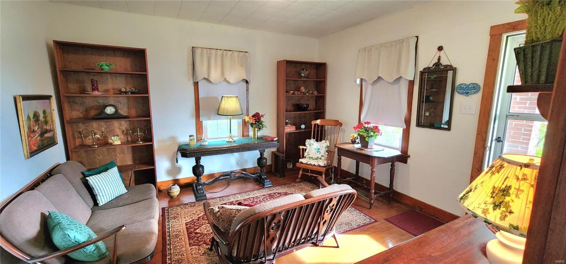 Living area with wood finished floors and baseboards