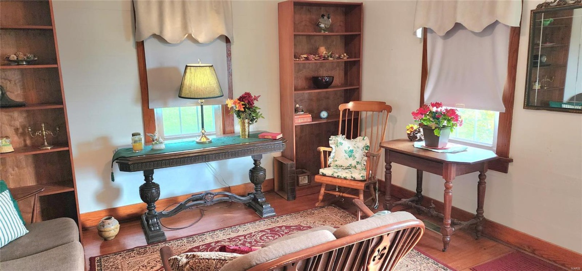 Living area featuring wood finished floors and baseboards