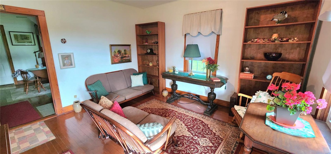Living room with wood finished floors and baseboards
