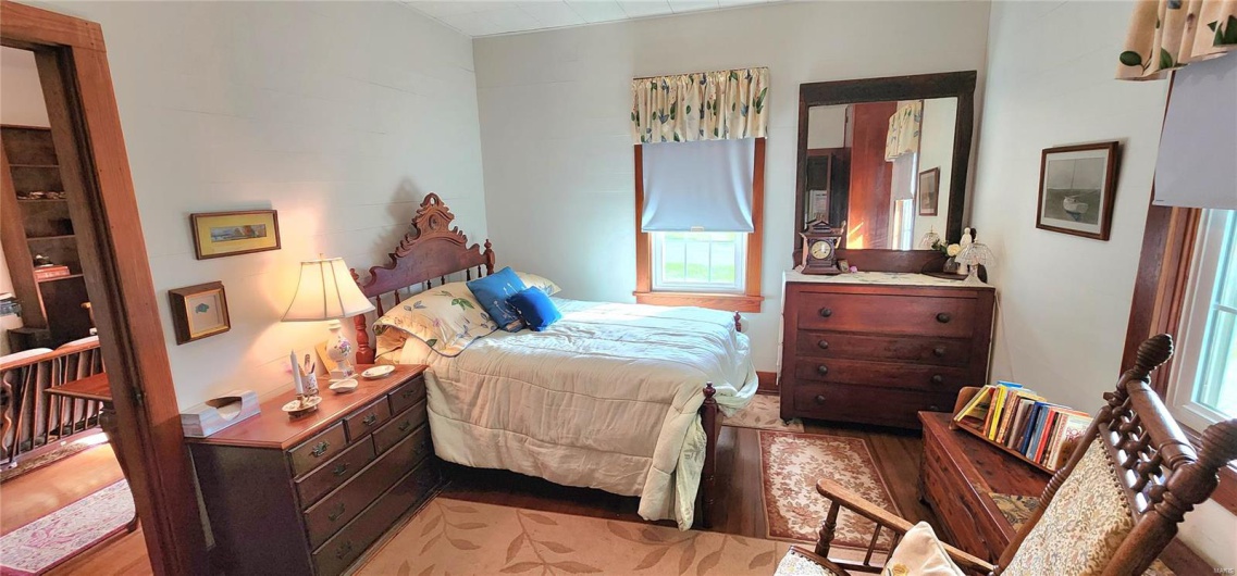 Bedroom featuring light wood-style floors and multiple windows