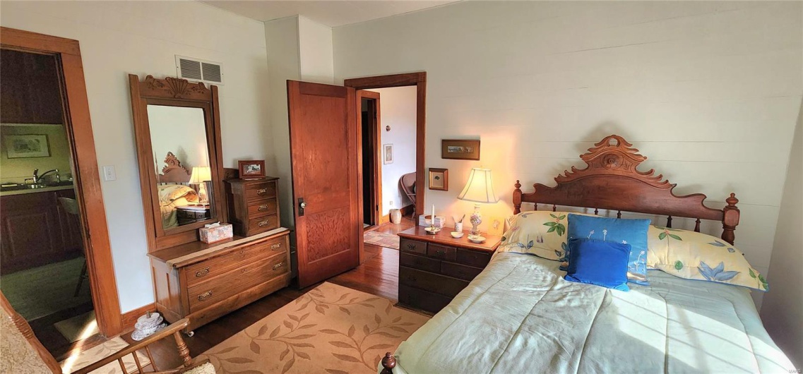 Bedroom featuring dark wood-type flooring and a sink