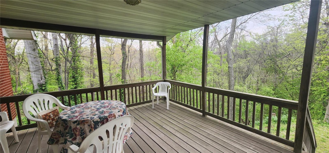 Wooden deck featuring a view of trees