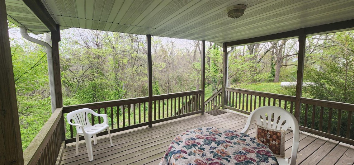 Wooden deck featuring a wooded view