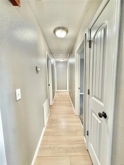 Hallway with baseboards and light wood-type flooring