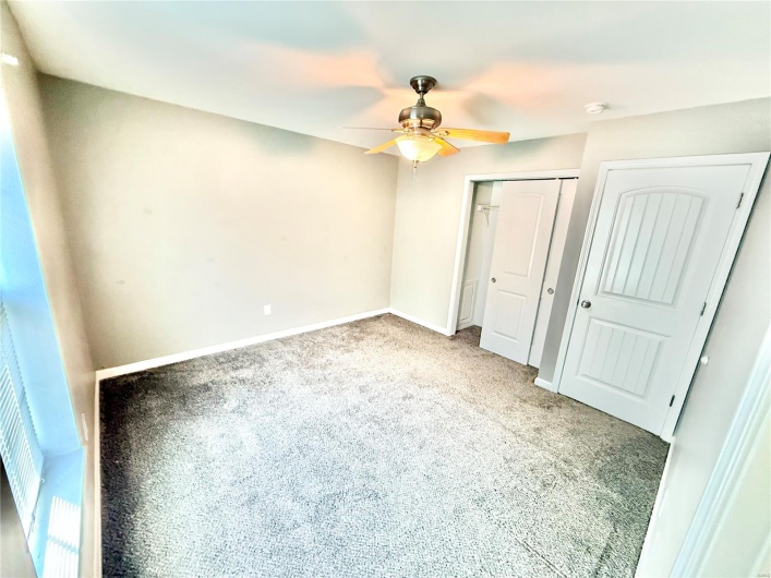 Unfurnished bedroom featuring carpet, a closet, a ceiling fan, and baseboards