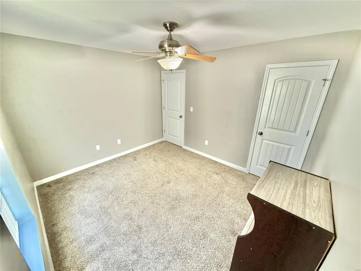 Unfurnished bedroom featuring carpet, a ceiling fan, and baseboards
