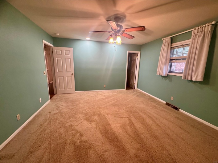 Unfurnished room with carpet floors, ceiling fan, and baseboards