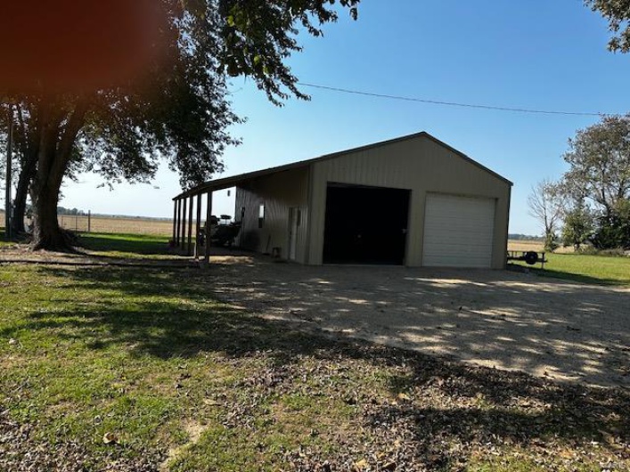 Garage featuring a yard