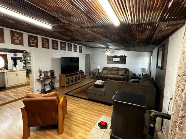 Living room featuring light wood-type flooring and ceiling fan