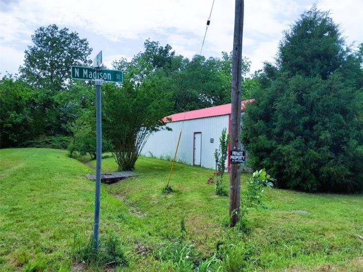 View of yard featuring a pole building and an outbuilding