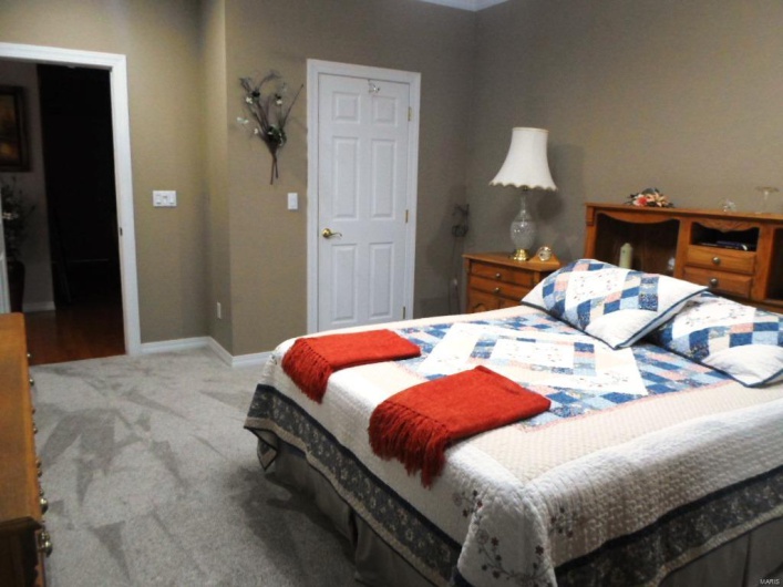 Bedroom with baseboards and carpet flooring