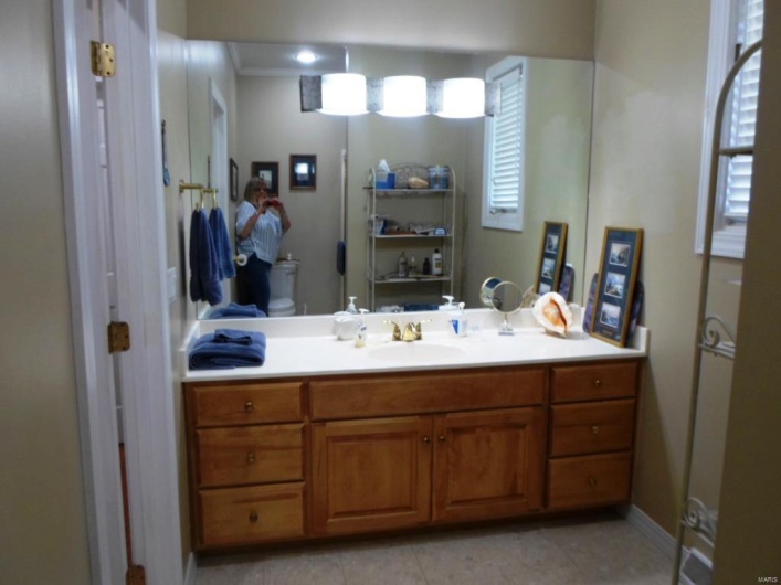 Bathroom featuring tile patterned flooring, vanity, and plenty of natural light