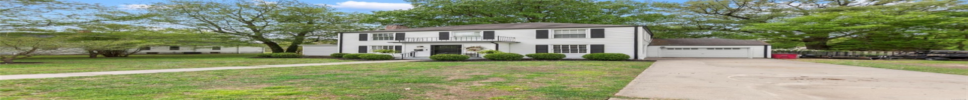 Residential For Sale Colonial home with a balcony, a chimney, concrete driveway, an attached garage, and a front yard