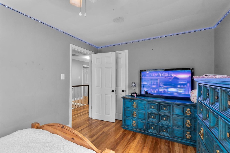 Bedroom featuring wood finished floors and a closet