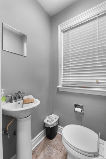 Half bathroom with baseboards and toilet