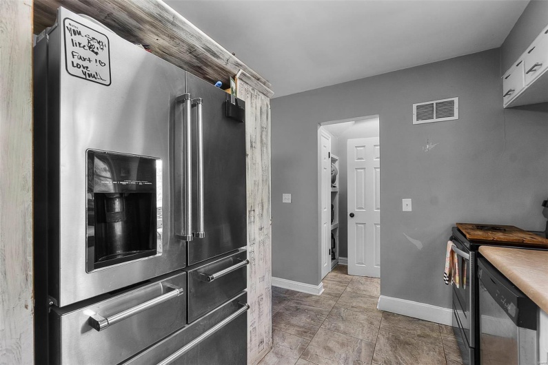 Kitchen featuring visible vents, appliances with stainless steel finishes, and baseboards