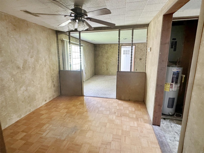 Spare room with electric water heater and a ceiling fan