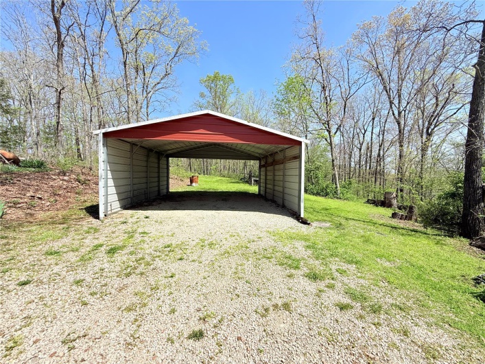 View of car parking with driveway and a carport